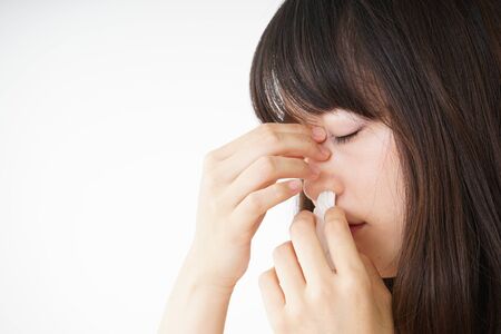 Young woman getting a bloody noseの写真素材