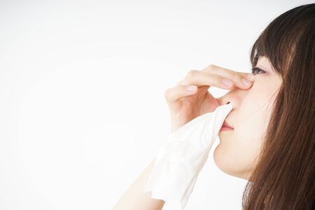 Young woman getting a bloody noseの写真素材