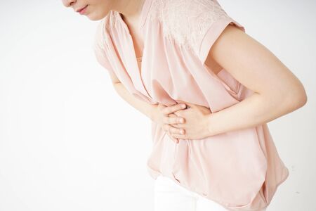 Young woman suffering from a stomachacheの写真素材
