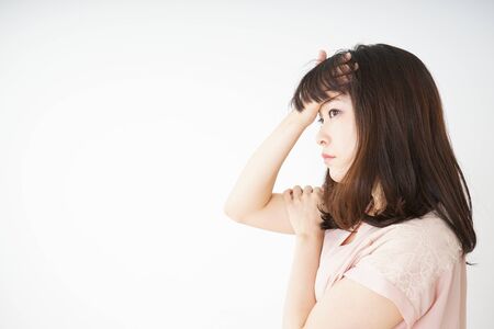 Young woman developing a fever because of a coldの写真素材