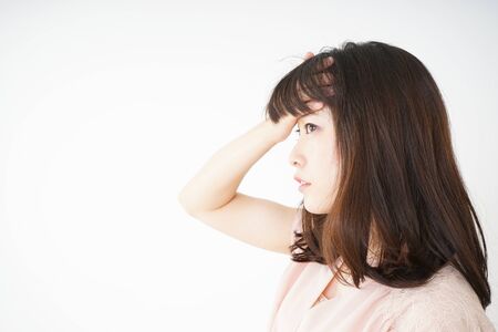 Young woman developing a fever because of a coldの写真素材