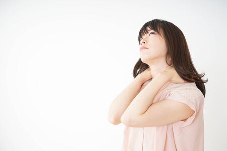 Young woman feeling stiff in her shouldersの写真素材