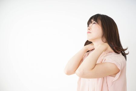 Young woman feeling stiff in her shouldersの写真素材