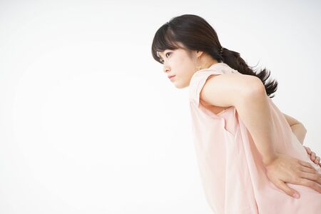 Young woman have a back problemの写真素材