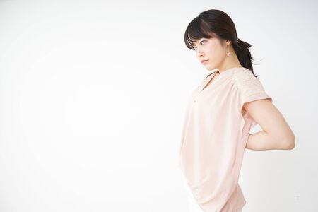 Young woman have a back problemの写真素材