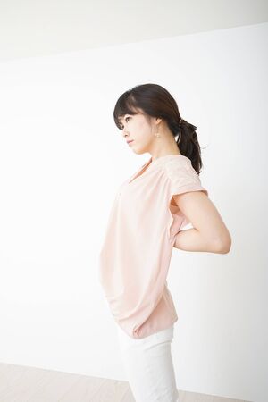 Young woman have a back problemの写真素材
