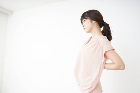 Young woman have a back problemの写真素材