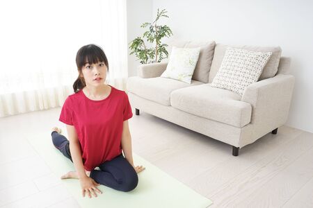 Young woman stretchingの写真素材
