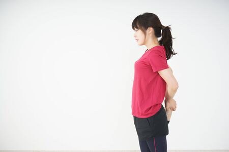 Young woman stretchingの写真素材