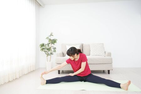 Young woman stretchingの写真素材