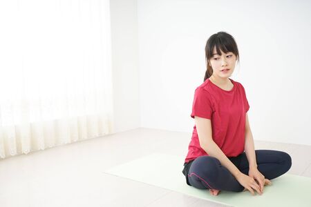 Young woman stretchingの写真素材