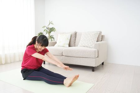 Young woman stretchingの写真素材