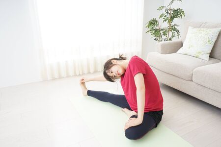Young woman stretchingの写真素材
