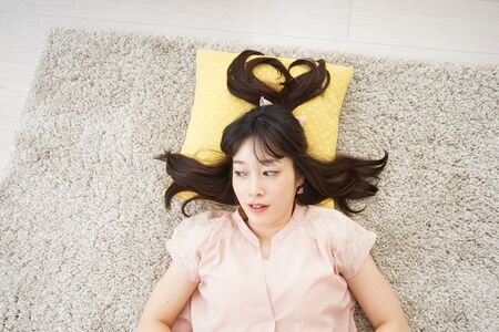 Young woman sleeping at homeの写真素材