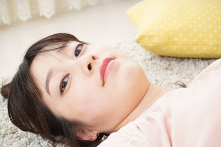 Young woman sleeping at homeの写真素材