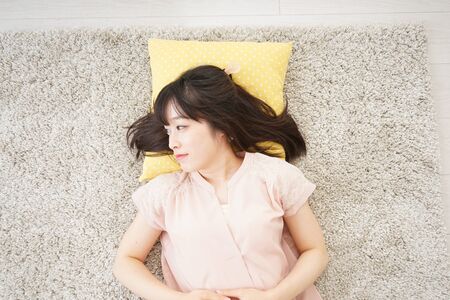 Young woman sleeping at homeの写真素材