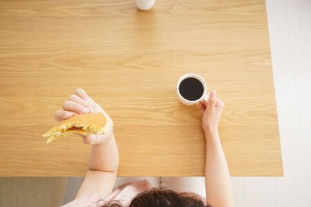 Young woman having a breakfastの写真素材
