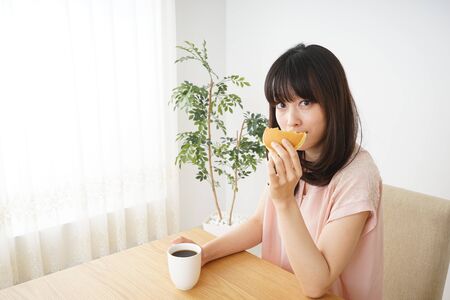 Young woman having a breakfastの写真素材