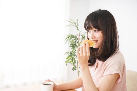 Young woman having a breakfastの写真素材