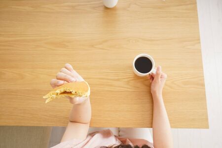 Young woman having a breakfastの写真素材