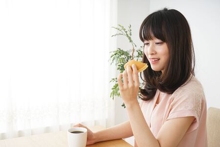 Young woman having a breakfastの写真素材