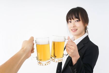 Businesswoman in suit cracking a beerの写真素材