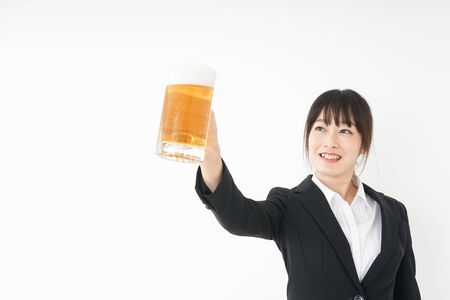 Businesswoman in suit cracking a beerの写真素材