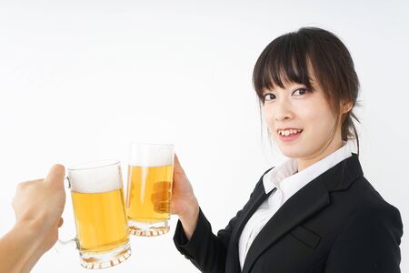 Businesswoman in suit cracking a beerの写真素材