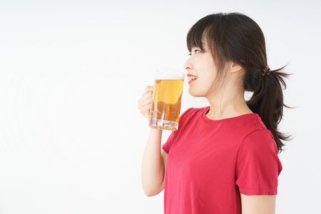 Young woman cracking a beer after an exerciseの写真素材