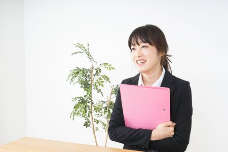 Young woman having some documents at officeの写真素材