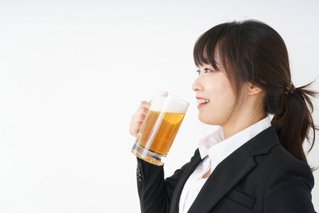 Businesswoman in suit cracking a beerの写真素材
