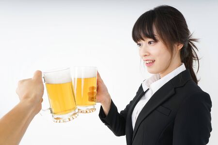 Businesswoman in suit cracking a beerの写真素材