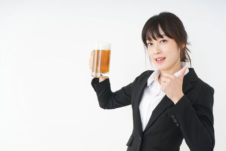 Businesswoman in suit cracking a beerの写真素材