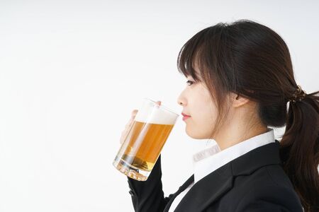 Businesswoman in suit cracking a beerの写真素材