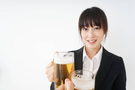 Businesswoman in suit cracking a beerの写真素材