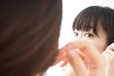 Young woman caring for skin problemsの写真素材