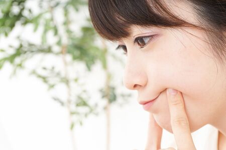 Young woman caring for skin problemsの写真素材
