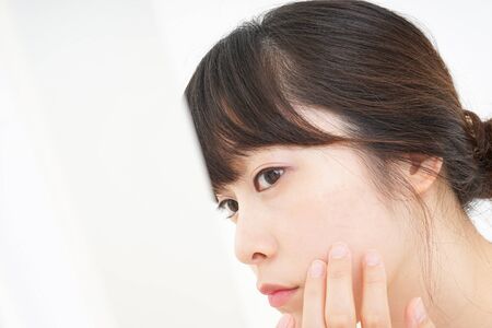 Young woman caring for skin problemsの写真素材