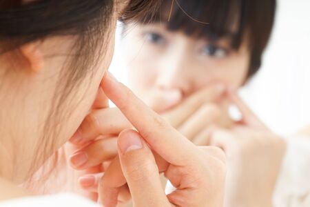 Young woman caring for skin problemsの写真素材