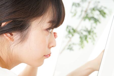Young woman caring for skin problemsの写真素材