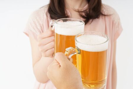 Young woman drinking beerの写真素材