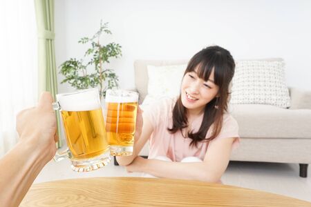 Young woman drinking beerの写真素材