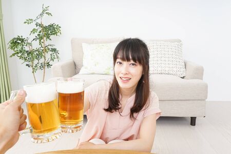 Young woman drinking beerの写真素材