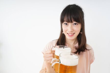 Young woman drinking beerの写真素材