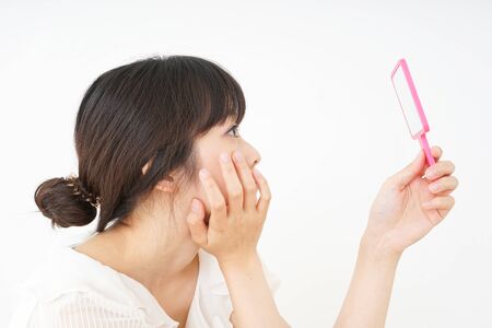 Young woman caring for skin problemsの写真素材