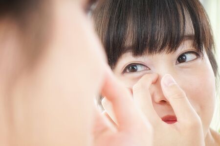 Young woman caring for skin problemsの写真素材