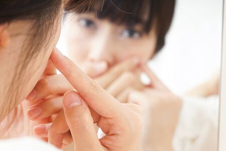 Young woman caring for skin problemsの写真素材