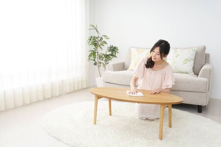 Young woman cleaning her houseの写真素材