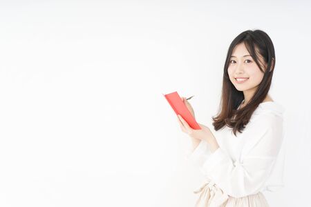 Young woman taking a noteの写真素材