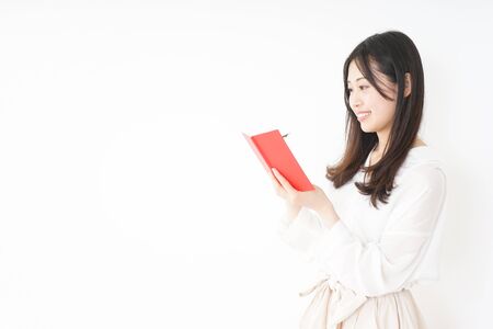 Young woman taking a noteの写真素材